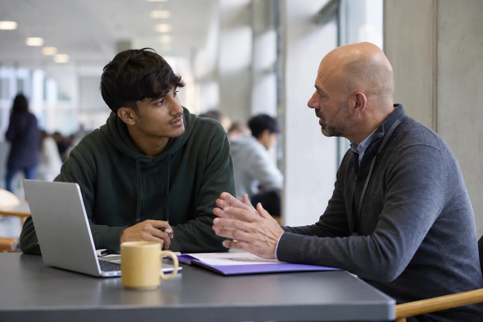 Students studying together in a bright academic workspace.